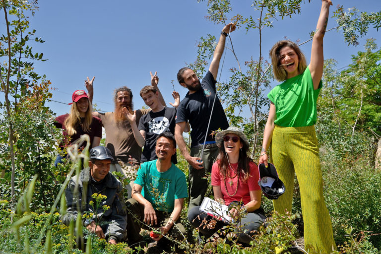 Omar al-Sharif, Motoharu Nochi, and a team of volunteers after a “growth monitoring” activity at the Marka baby forest in April 2022.