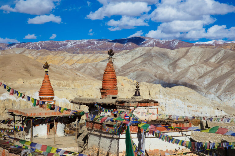 Chörtens right outside the walled city of Lo Manthang. Image by Jean-Marie Hullot via Flickr (CC BY 2.0 Deed).