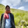 Desta Melaku, one of the board member of Guassa Community Conservation Office, stands in front of a field of guassa grass. Image by Solomon Yimer for Mongabay.