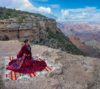 A Diné woman in a traditional dress, on the rim of Grand Canyon. Image courtesy of Grand Canyon National Park via via Flickr (CC BY-NC-ND 2.0).