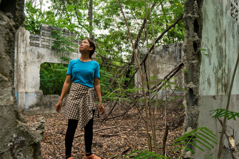 Premsinee in the ruin of her old school.