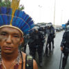 An Apiaká Indigenous leader in front of police blockade