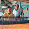 Radhavato Devi training an Indigenous woman to make sari with banana fiber.