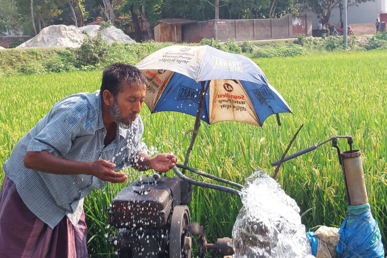 A man in the western Chuadanga district splashes water on his face from an irrigation pump to get relief from the heat.