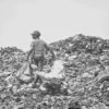 A boy sorts through the waste in a landfill