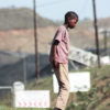 A boy playing near Tendele's washing plant: the coal mine has impacted life in the community. Image by Rob Symon via Flickr (CC BY-NC-ND 2.0)