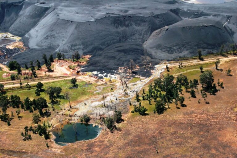 Aerial view of a massive pile of black coal looming over a small pool and scattered trees near Carolina, Mpumalanga, South Africa. Image courtesy Mpumalanga Tourism and Parks Authority.