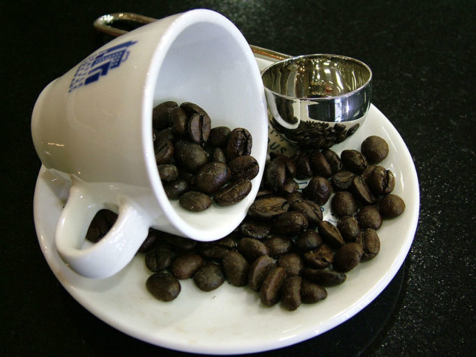 A coffee cup with beans. Photo by Lotus Head/Wikimedia Commons