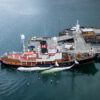 The harpoon or catcher ship Hvalur 8 arrives at the whaling station in Hvalfjörður, West Iceland. Two fin whales are tied to the starboard side of the ship. Image by Arne Feuerhahn / Hard to Port.