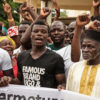 Close up of men chanting at a protest in Cayar, Senegal. Image © Greenpeace / Annika Hammerschlag.