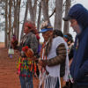 A group of Guarani-Kaiowá residents dance and chant.