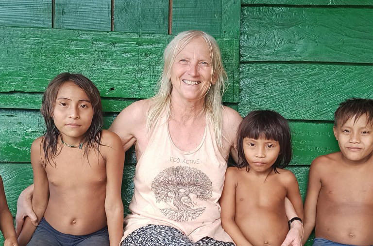 Christina Haverkamp (center), founder of the German NGO Hilfe Yanomami, with Indigenous children. The activist has been going to Brazil since the 1990s and says wildcat miners are disrupting the life of the Yanomami people. Image courtesy of Hilfe Yanomami.