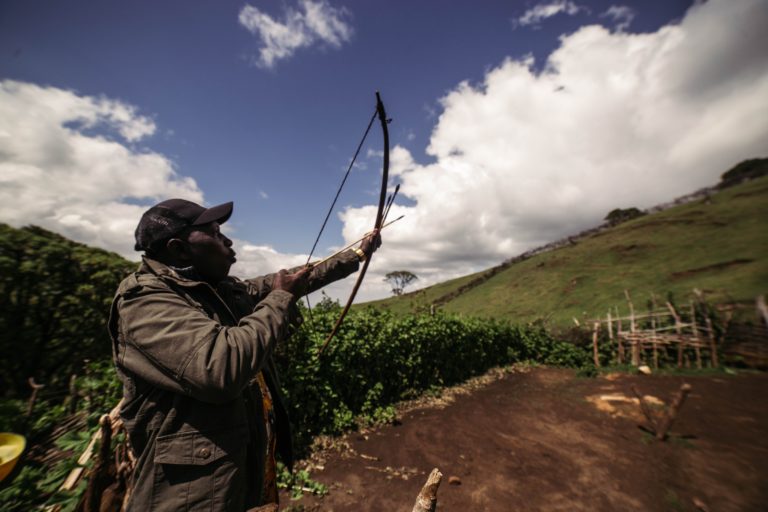 Kibiwot displaying his archery skills at his makeshift home in the Embobut, which has been burned down many times by KFS as part of forceful evictions.
