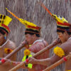 Kuikuro men playing flutes.