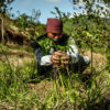 A ranger planting a tree.