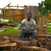 Peter Nagul sit on the rubble that used to be his house.