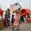 A man carries relief items.