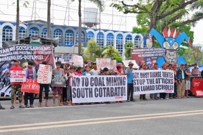 Activists and Indigenous peoples holding a protest.