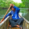 Victor Emata, a SEAMANCOR-trained tour guide, rowing a boat.